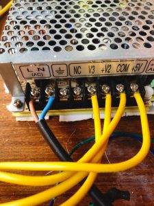 Detailed shot of electronic power supply unit showing wiring and connectors.
